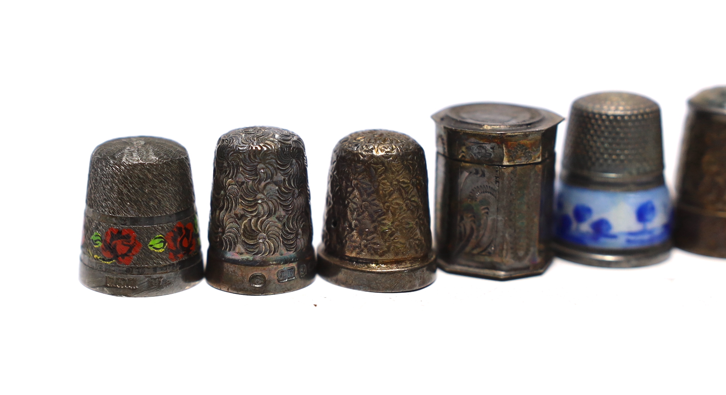 Seven assorted early 20th century and later silver thimbles, including two enamelled and a Dutch? white metal octagonal thimble case.